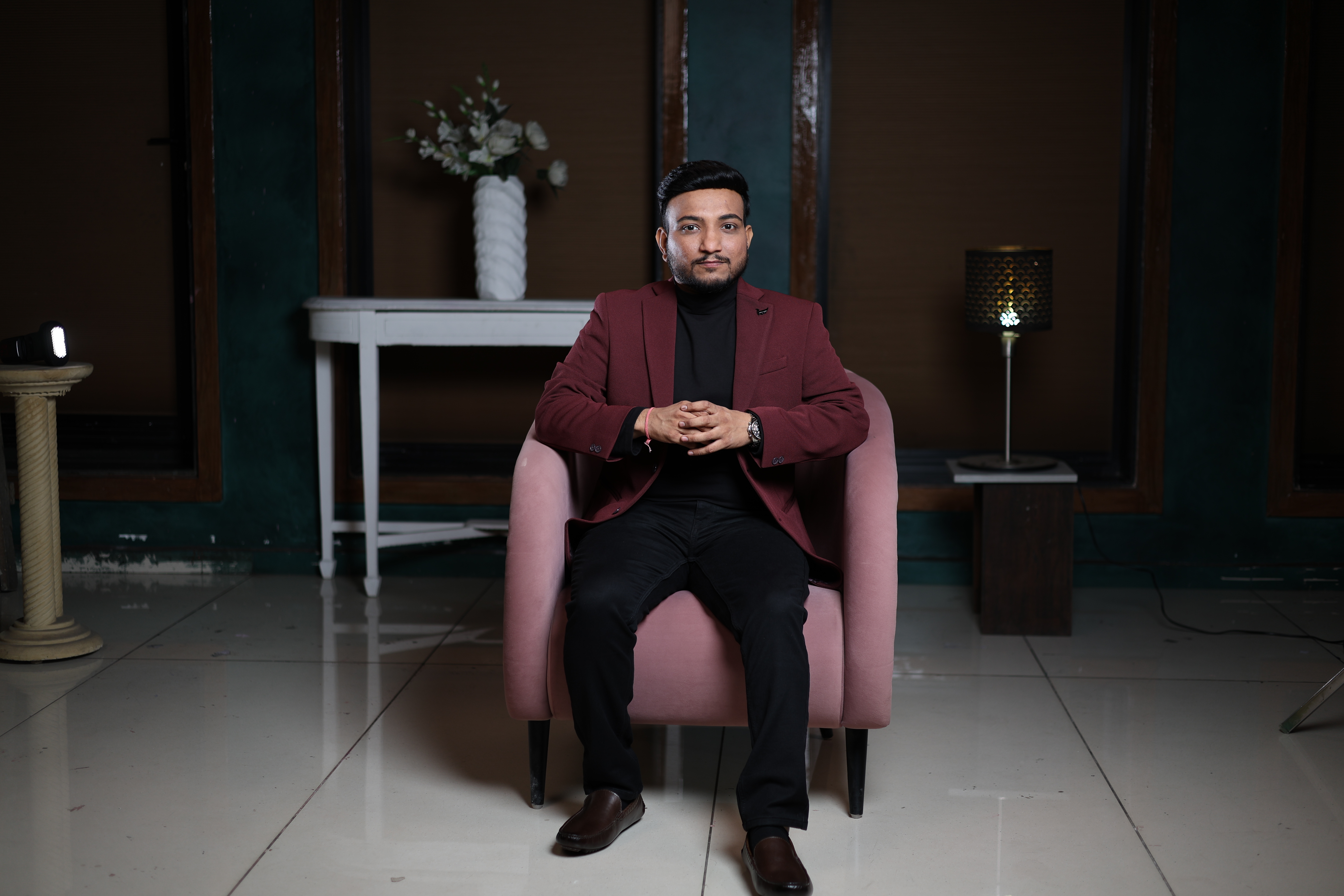 Sagar Shah, AI Implementation Coach, seated with direct gaze